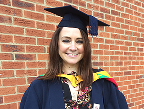 Student smiling to camera on her graduation day